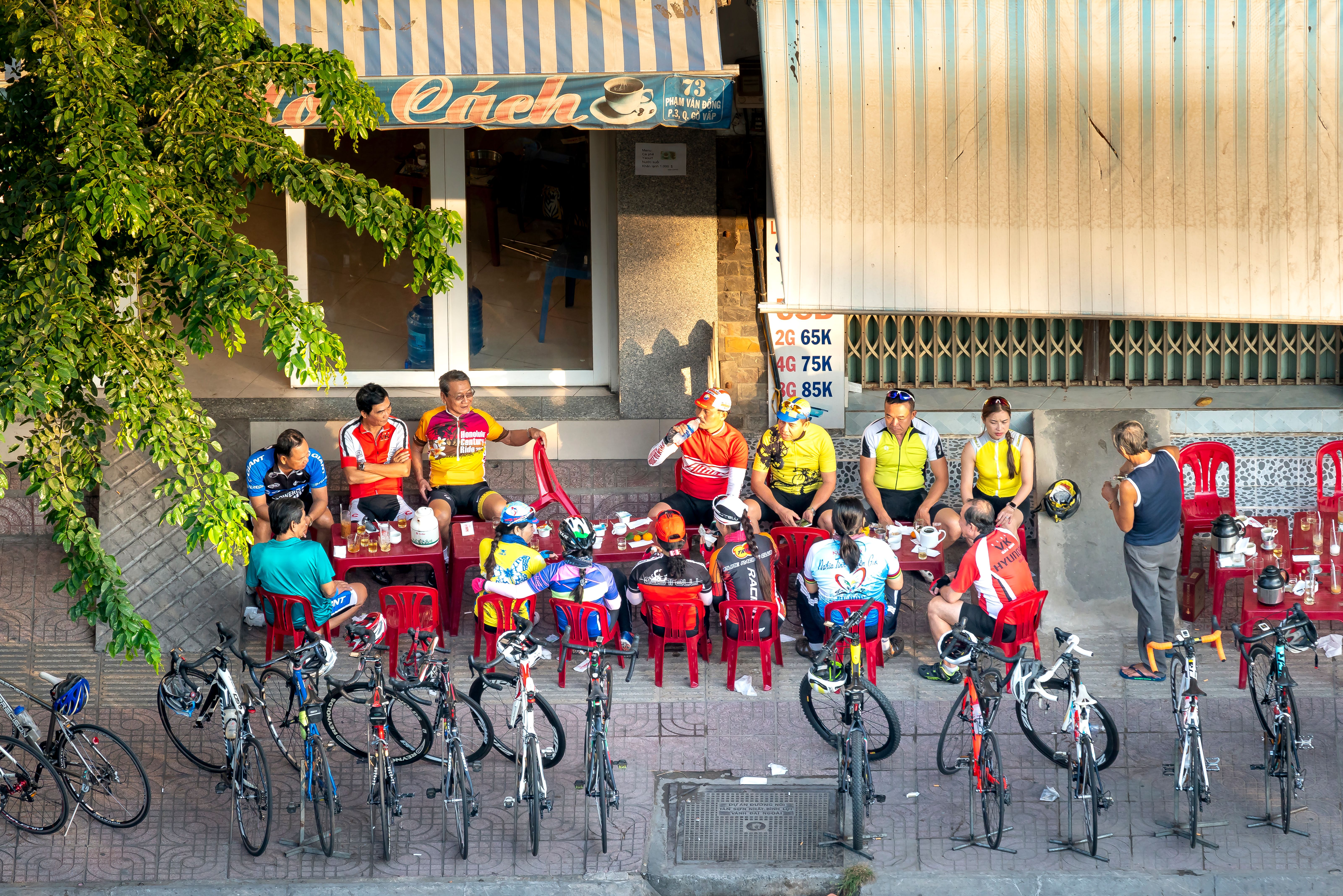 A group of cyclists gathering at a café after a ride